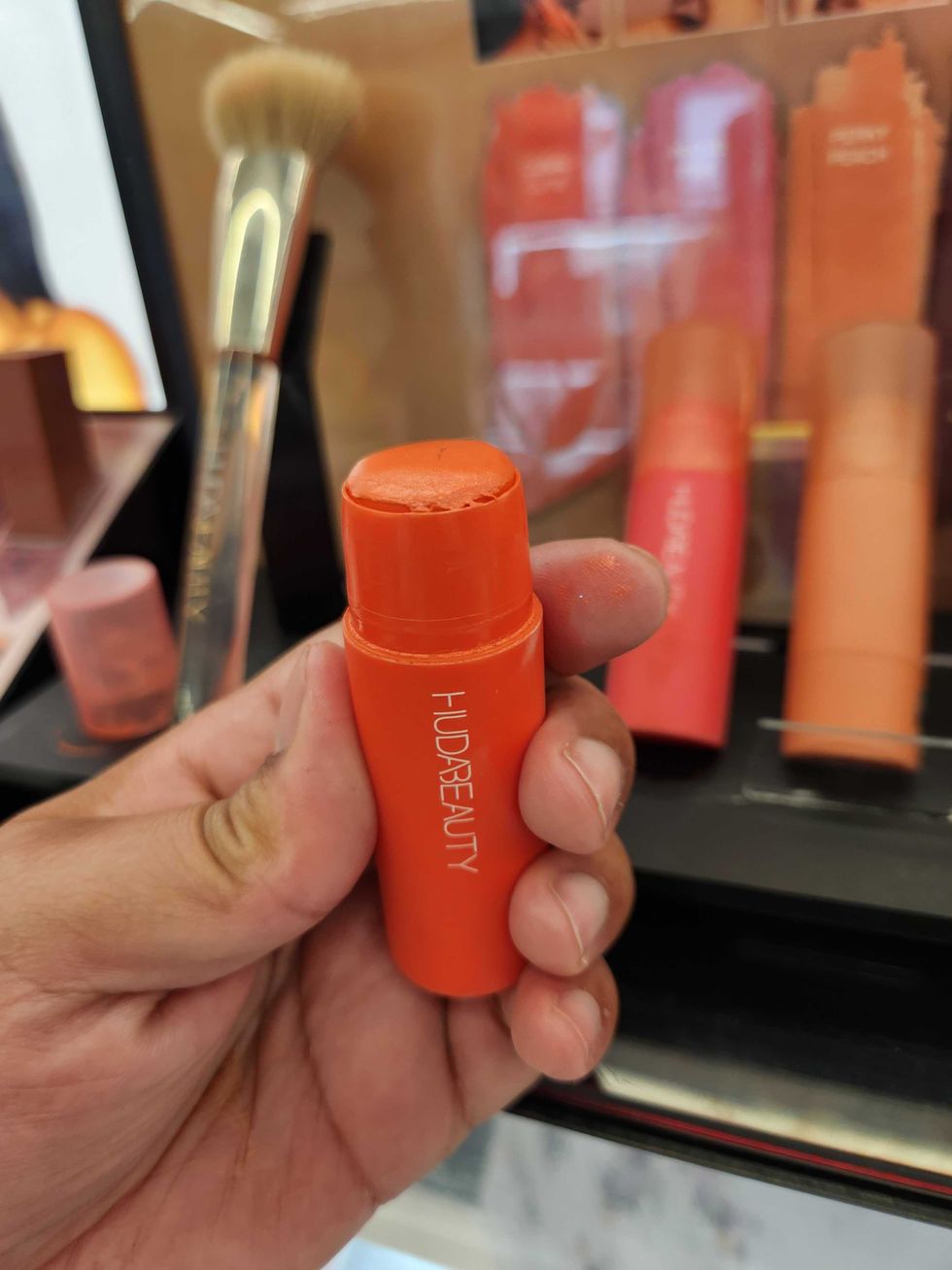 HUDA BEAUTY Cheeky Tint Cream Blush Stick in Coral Cutie at Sephora.