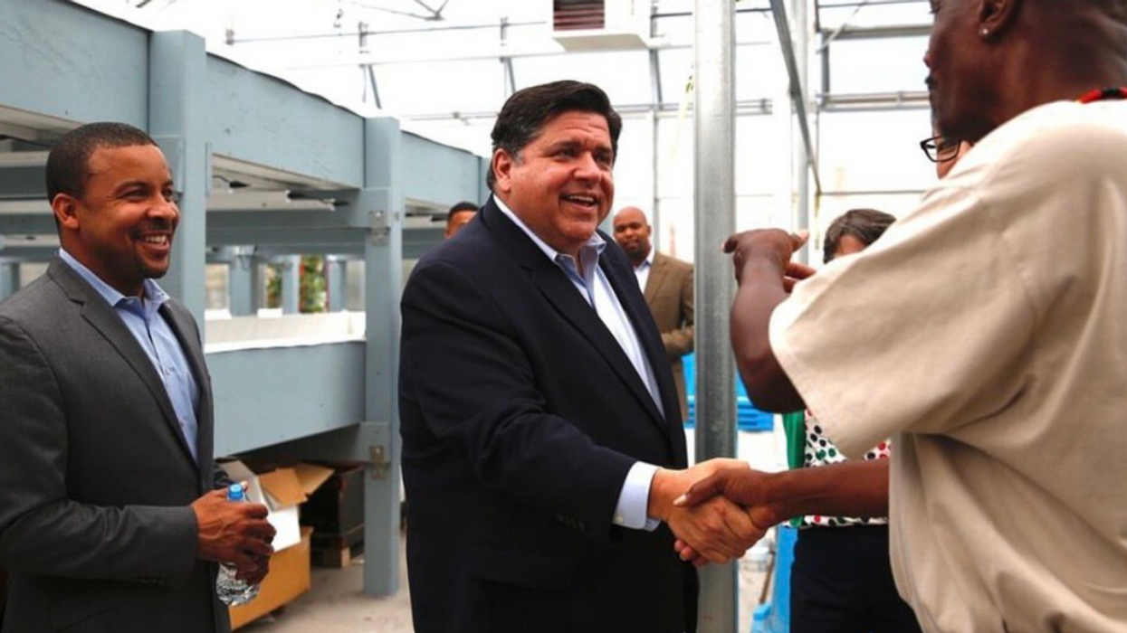 Illinois Governor Jay Robert "J.B." Pritzker shaking a person's hand.