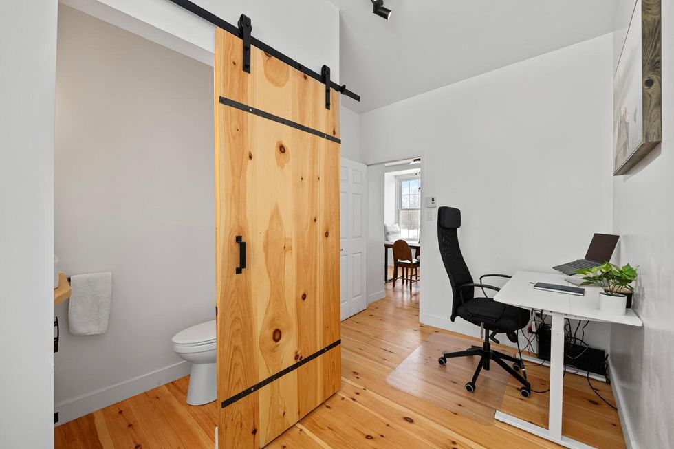 Interior of a home with a bathroom and office setup.