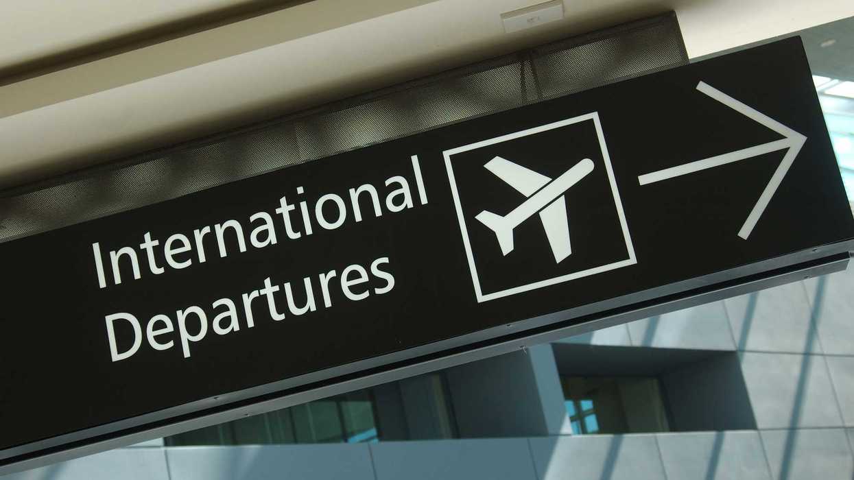 International Departures sign at an airport.
