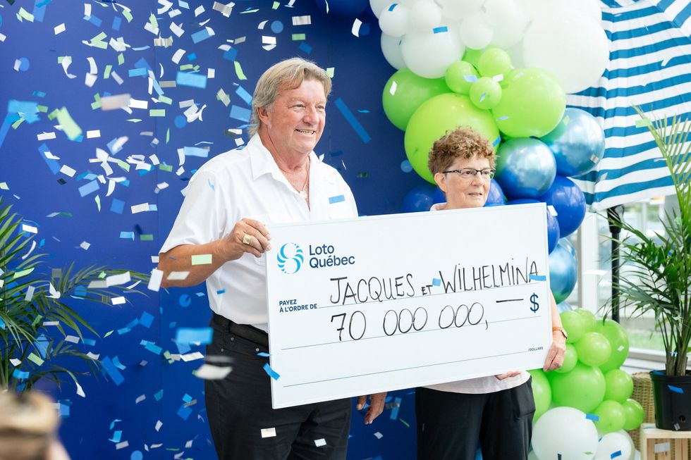 jacques deschamps and wilhelmina van leeuwen holding a $70 million lotto max cheque