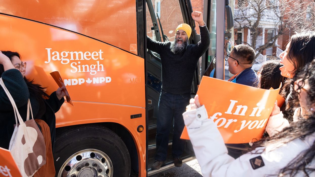 jagmeet singh on steps of ndp bus with supporters