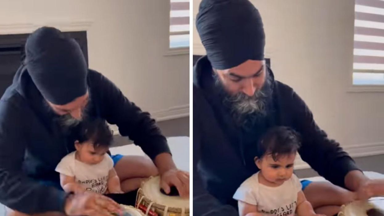 Jagmeet Singh sitting with his baby Anhad and playing hand drums.