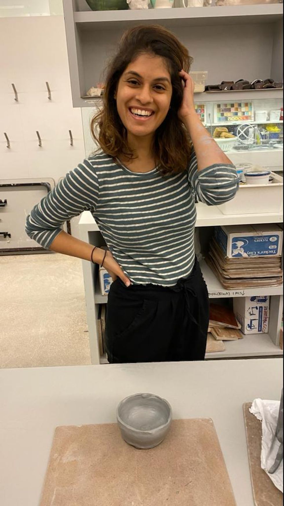 Janice Rodrigues poses with her creation after a pottery class in Toronto.