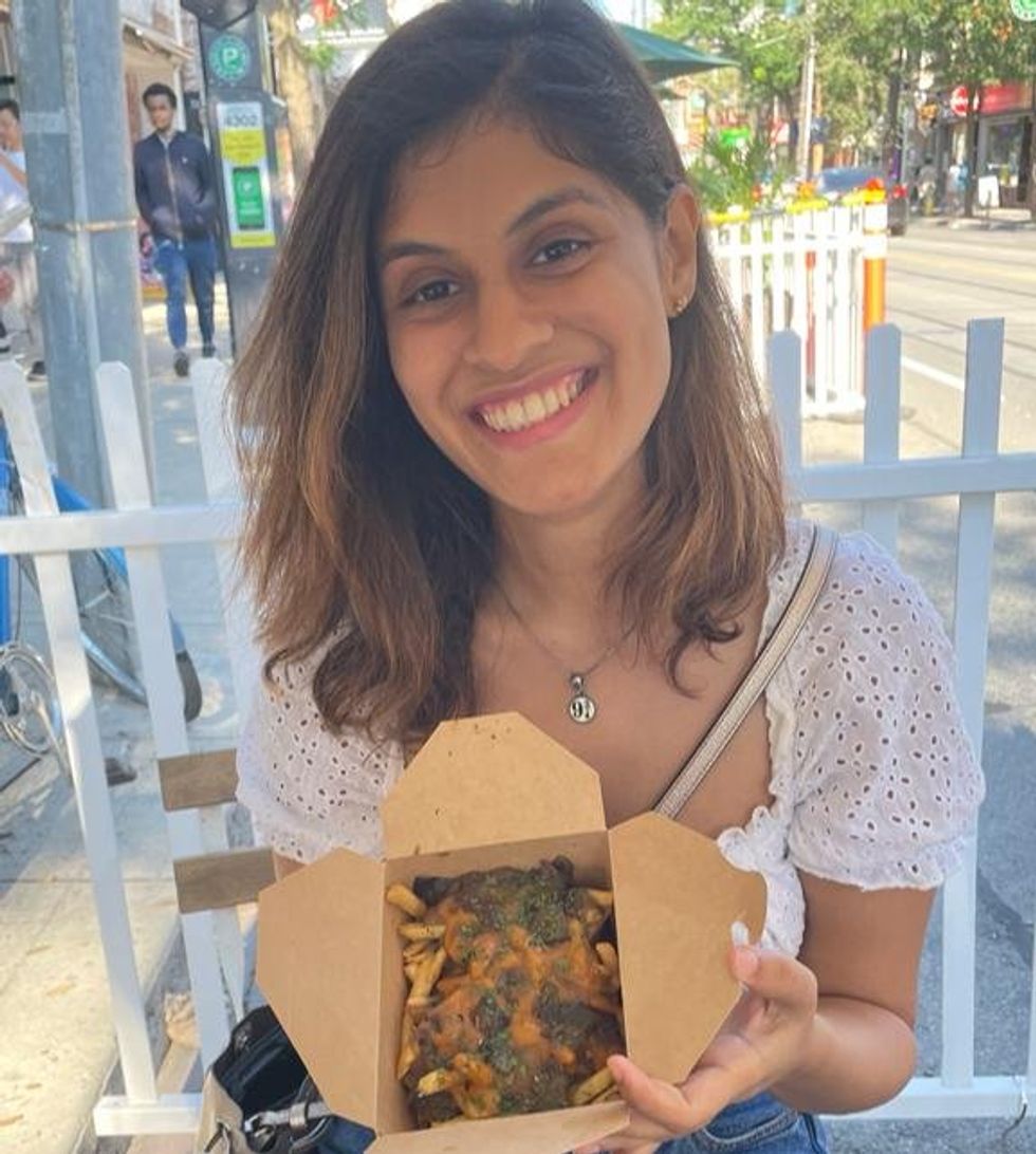 Janice Rodrigues trying poutine.