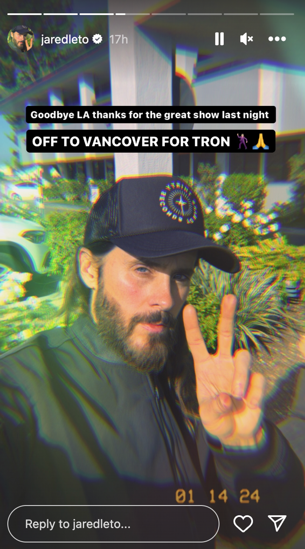 Jared Leto showing a peace sign while taking a selfie.