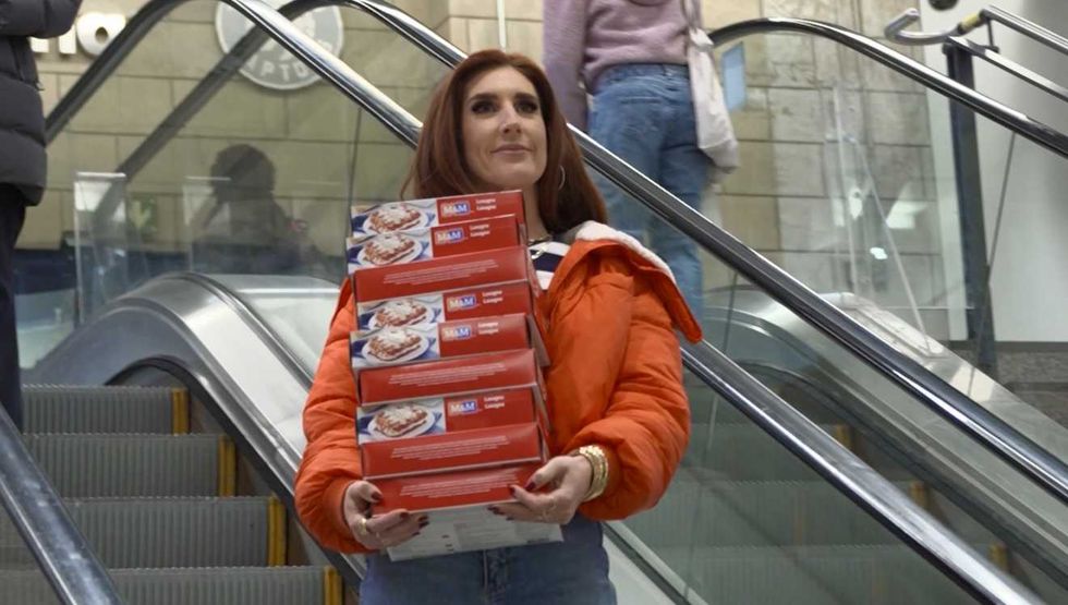 Jessi Cruickshank holding M&M Food Market Meals at Union Station