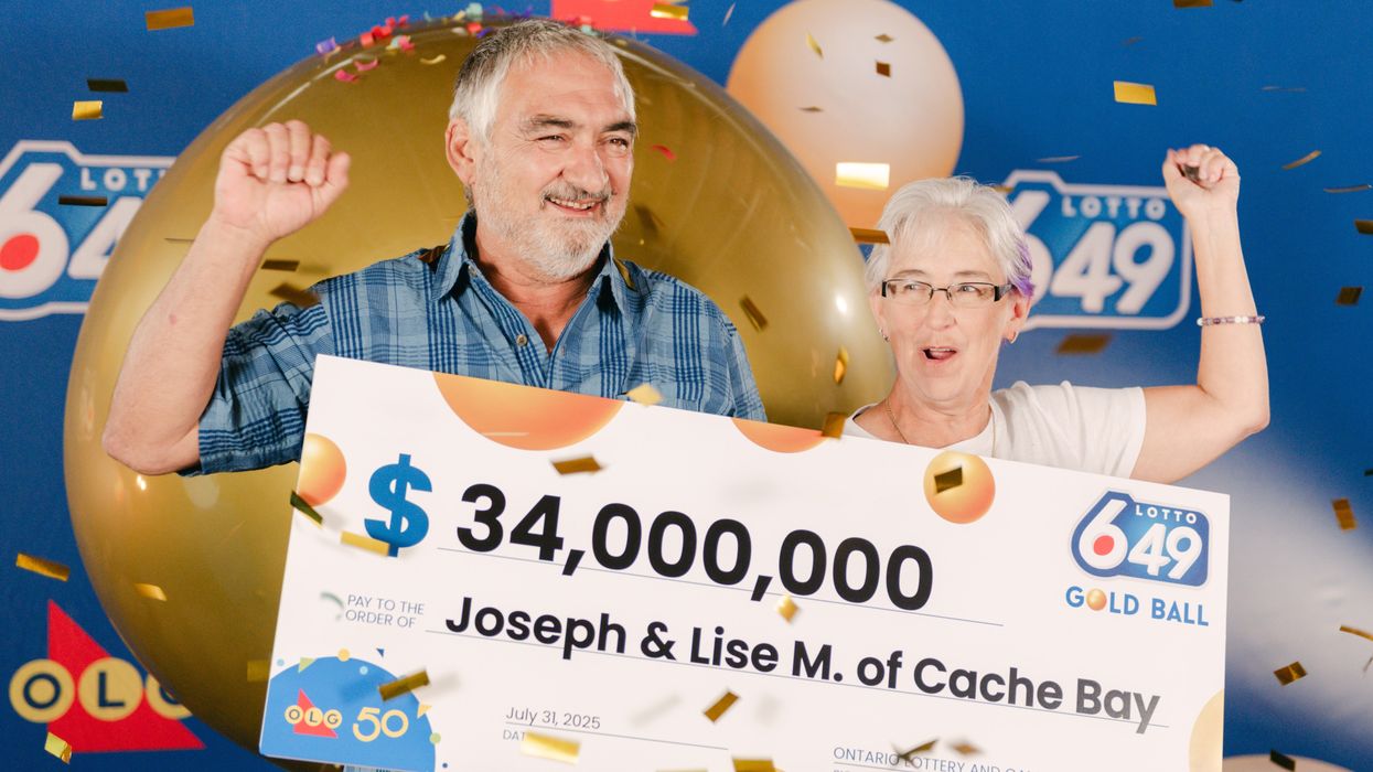 joe and lise menard holding a $34 million lotto 6/49 cheque