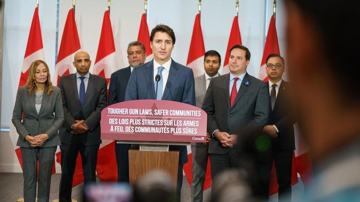 Justin Trudeau standing at a podium during an announcement of Canada's handgun freeze.
