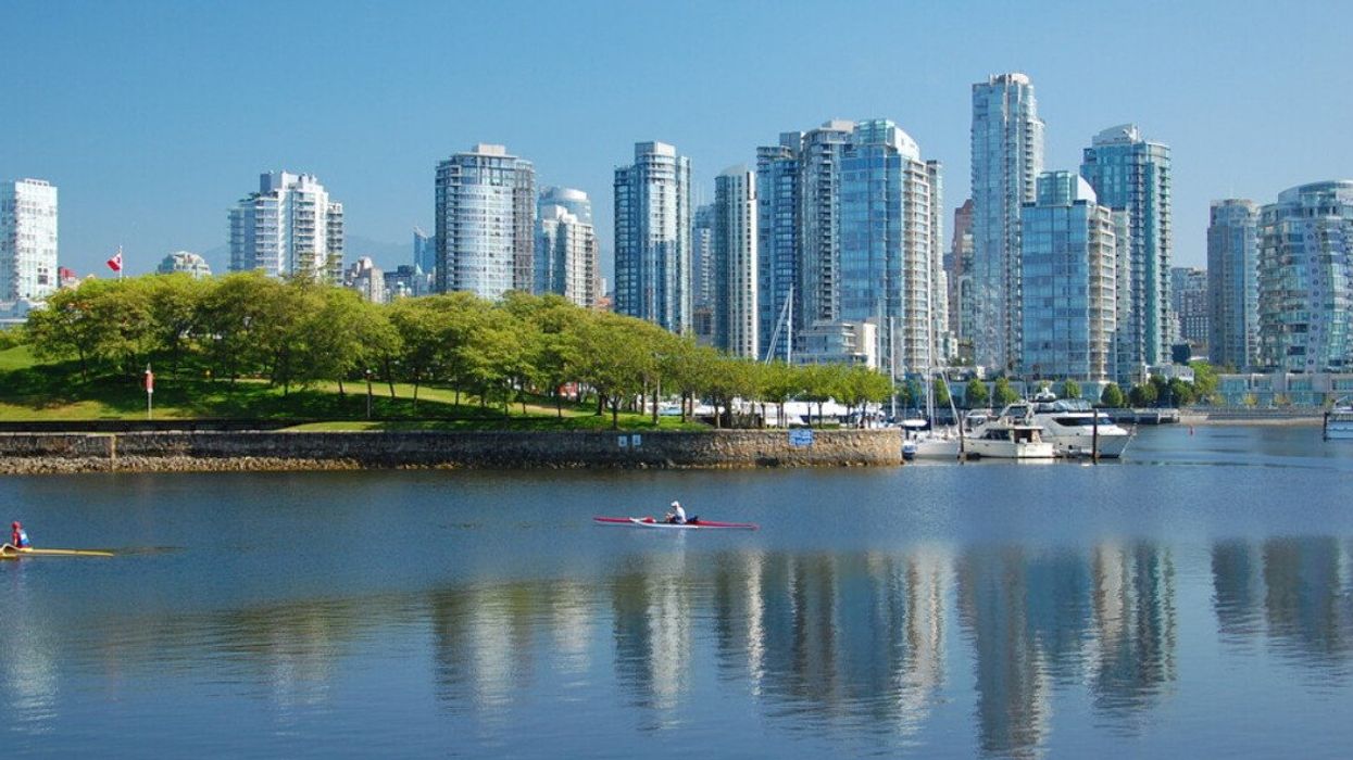 Kayakers with a city in the background.