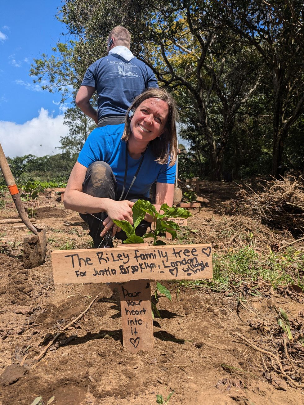 Kelsey Riley poses with the coffee sapling she planted at Hacienda Alsacia.