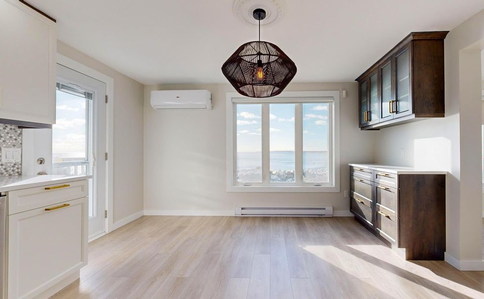 kitchen and dining room with windows showing the ocean