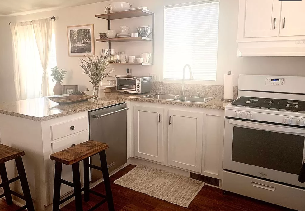 Kitchen area with white cabinets.