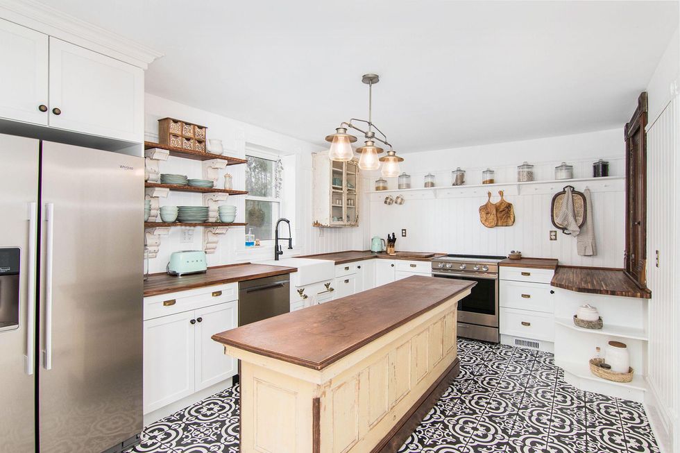 Kitchen with an island and tile flooring.