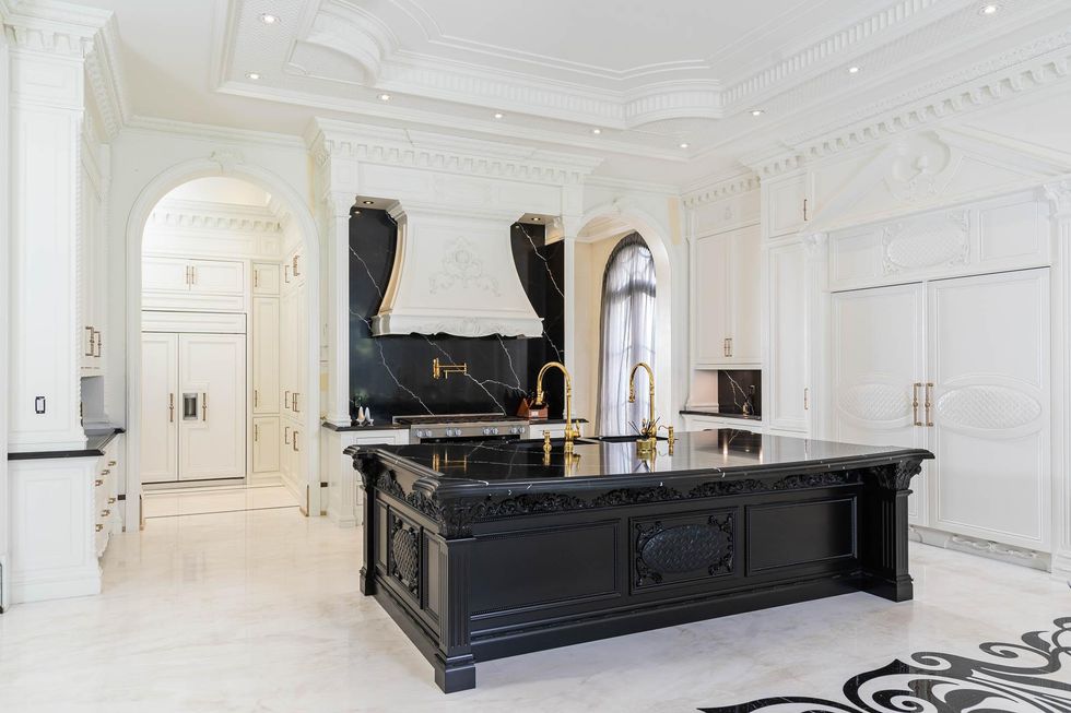 Kitchen with black marble island table.