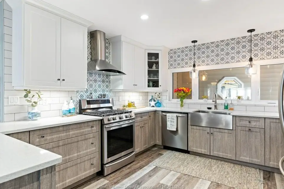 Kitchen with patterned tile and wooden cupboards.