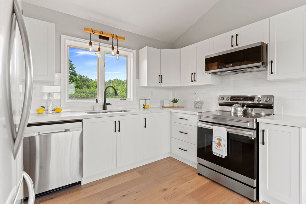 Kitchen with white cupboards.