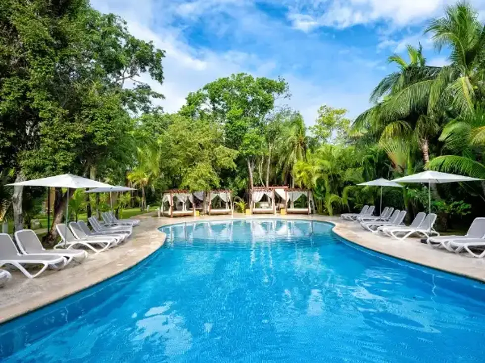 La piscine entour\u00e9e de chaises longues du Viva Maya By Wyndham.