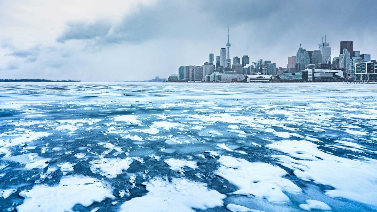 lake ontario covered in snow and ice with toronto skyline in the background