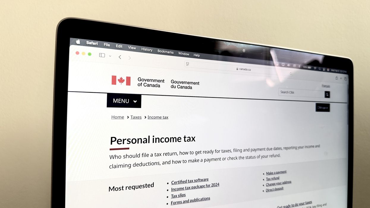 Laptop screen open on the CRA's "Personal income tax" web page.