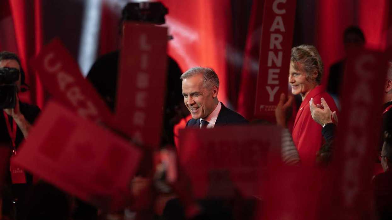 Liberal Leader Mark Carney turns to supporters after it was announced he won the leadership