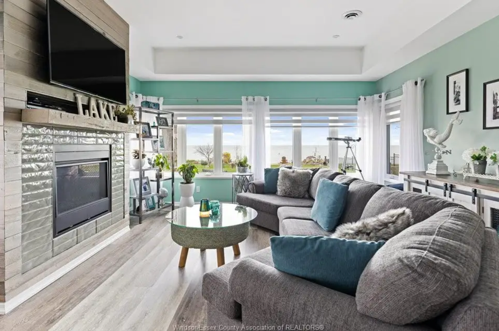 Living area with a fireplace and lake views.