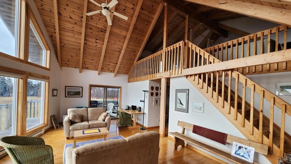Living room of the house with vaulted ceilings and a loft space.