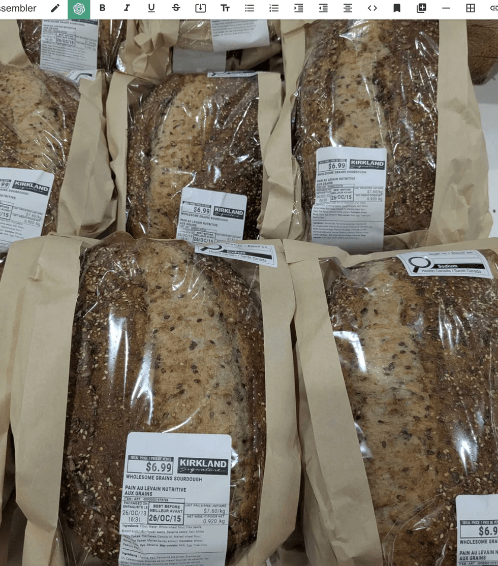 Loaves of Kirkland multigrain sourdough bread in paper packaging with price tags.
