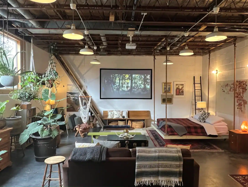 Loft with plants and exposed pipes.