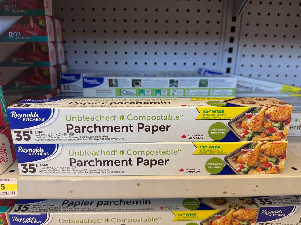 Long tubes on a store shelf that say unbleached parchment paper on them.
