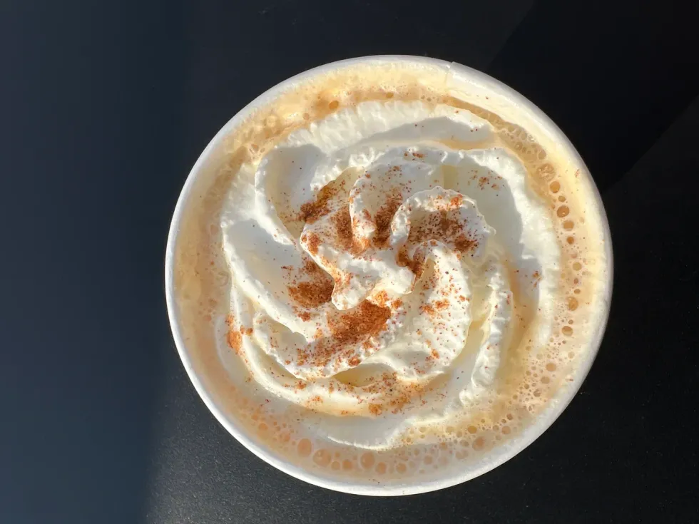 Looking down on a frothy pumpkin spice latte from Starbucks