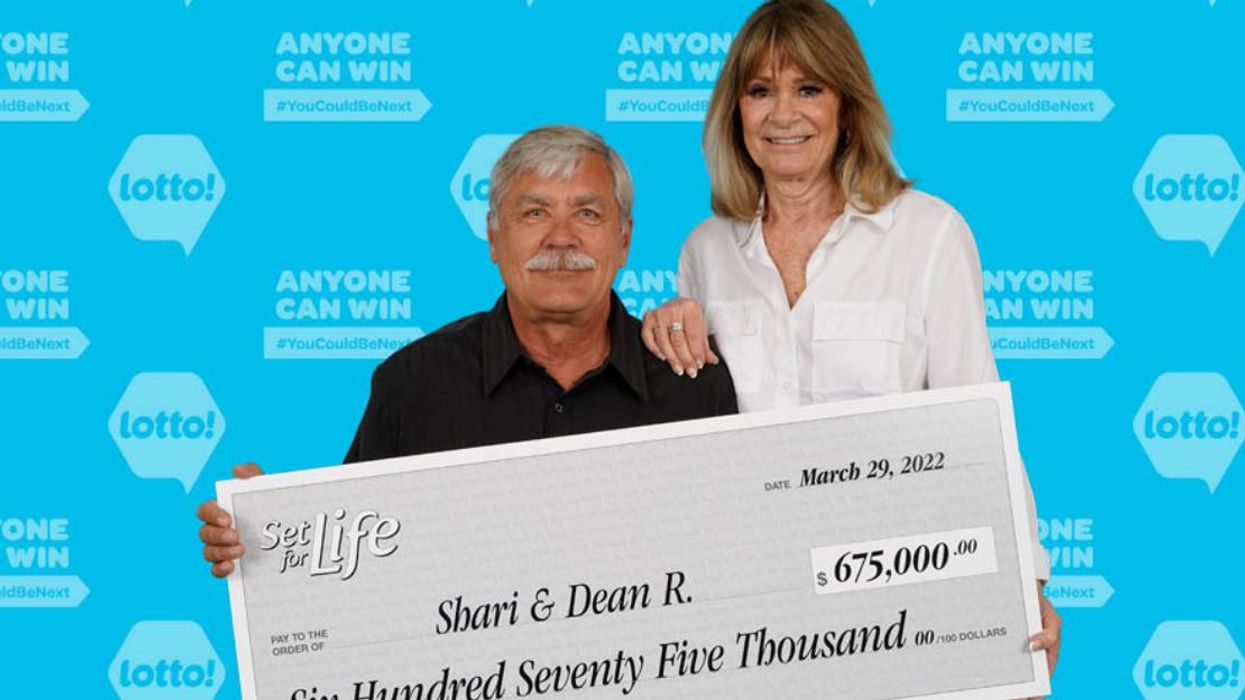 Lottery winners from B.C. holding their cheque.