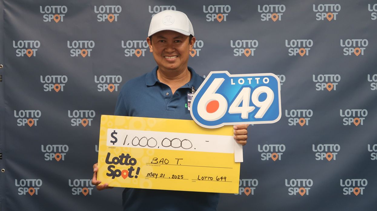 lotto 6/49 winner bao tran holding a million dollar cheque