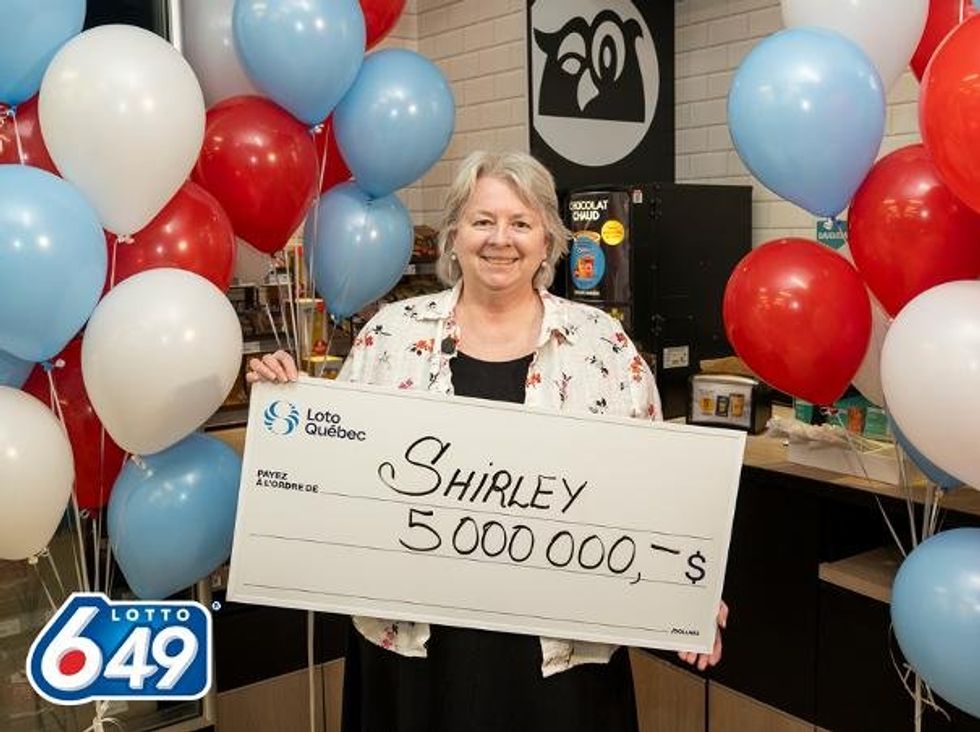 lotto 6/49 winner shirely huan holding a $5 million cheque