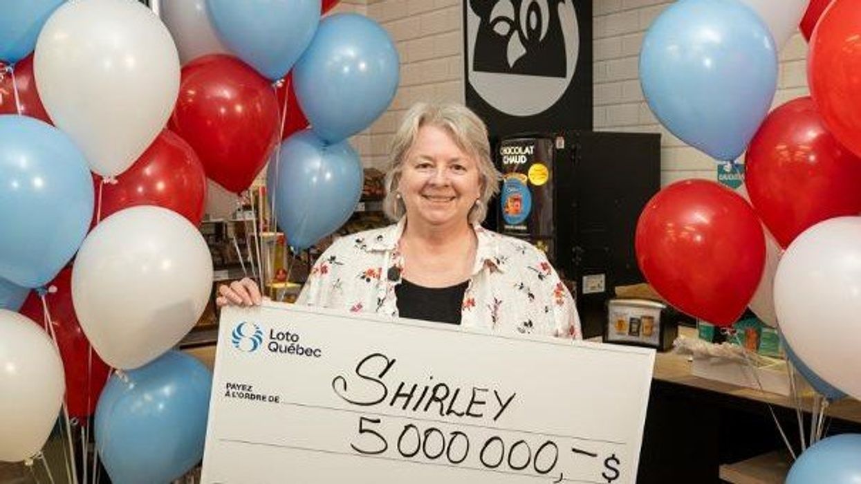 lotto 6/49 winner shirley huan holding a $5 million cheque