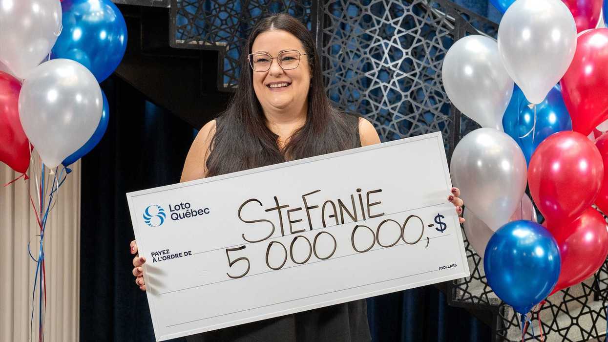 lotto 6/49 winner Stefanie Pepin holding a $5 million cheque