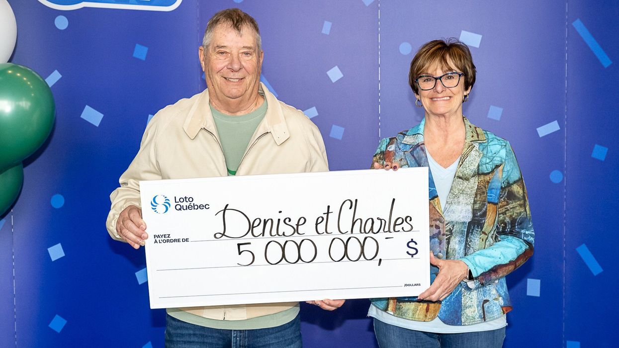 lotto 6/49 winners denise gauthier and charles bisaillon holding a $5 million cheque