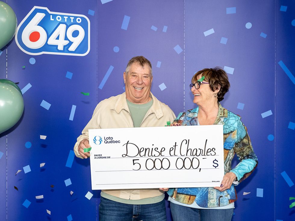 lotto 6/49 winners holding a $5 million cheque