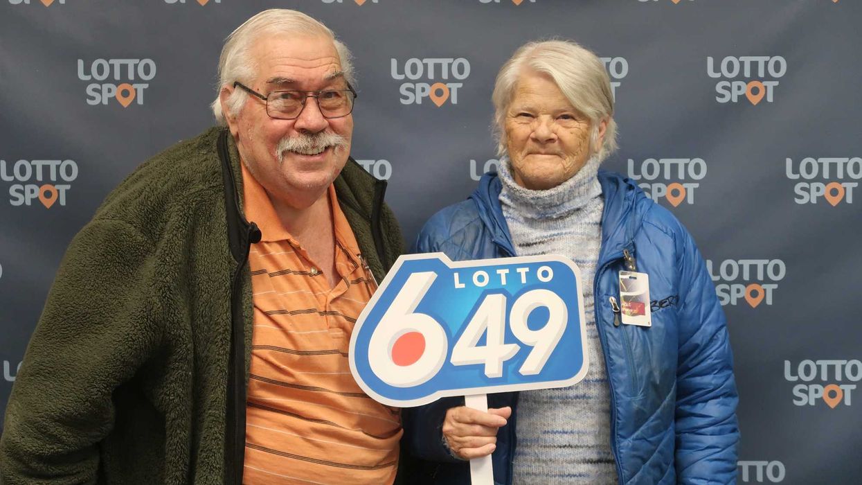 lotto 6/49 winners Judy and Dennis Korop with a lotto 6/49 sign