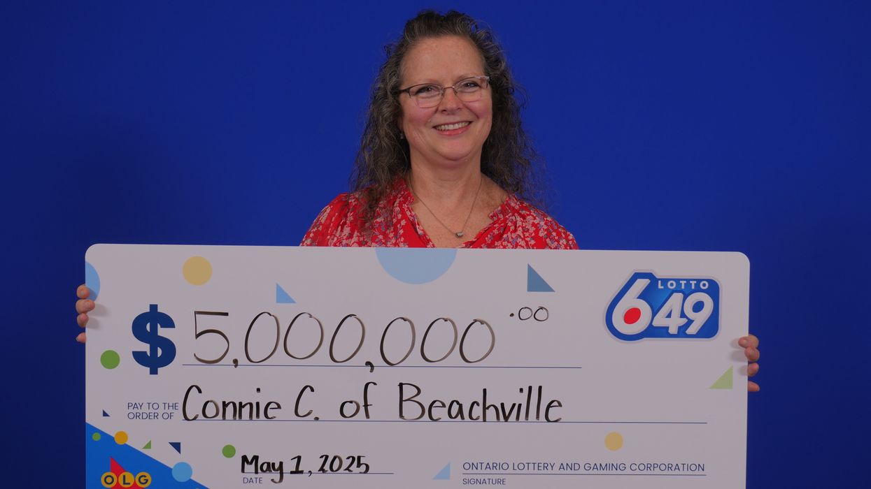 lotto 649 winner connie christie holding a $5 million cheque
