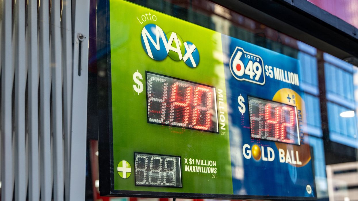 lotto max and lotto 6/49 signs in a store window displaying jackpot amounts