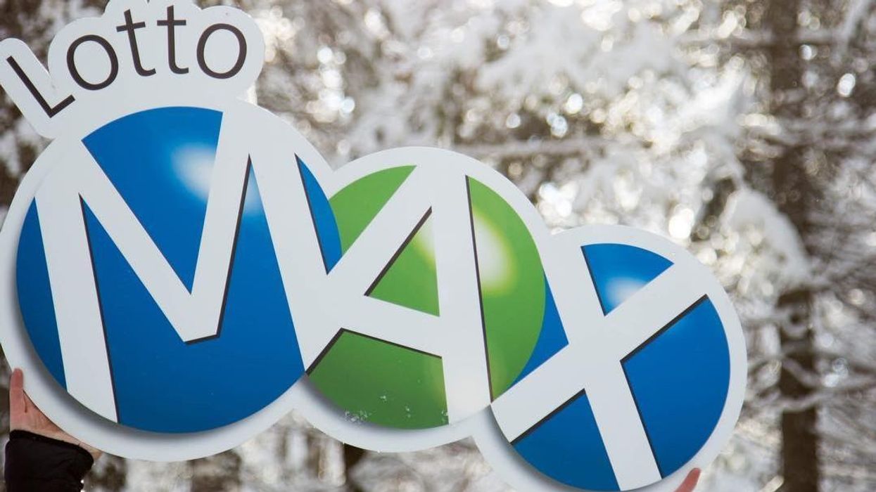 Lotto Max sign in a snow-covered forest.