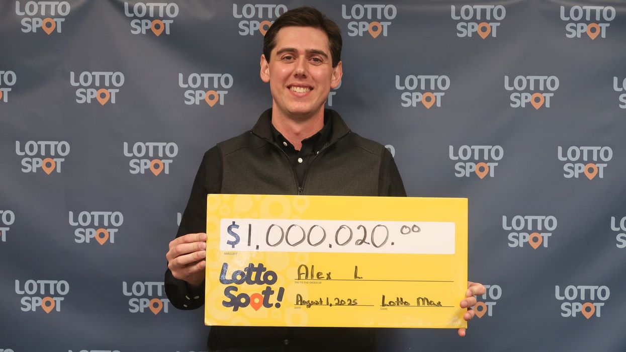 lotto max winner alex larson holding a $1 million cheque