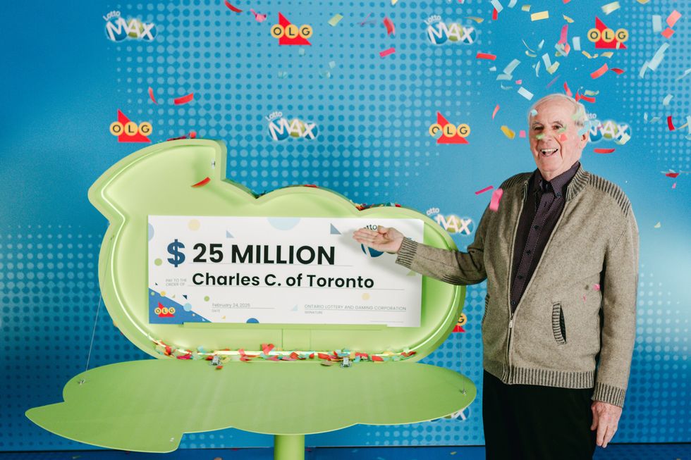 lotto max winner charles coffey with a $25 million lotto max cheque