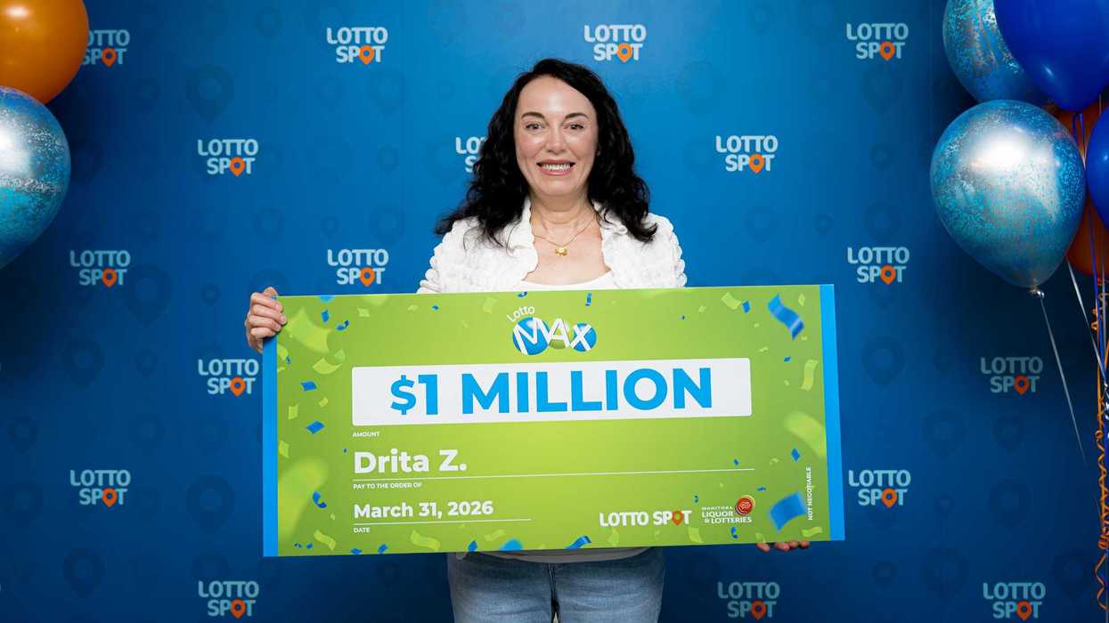 lotto max winner Drita Zeqiri holding $1 million cheque