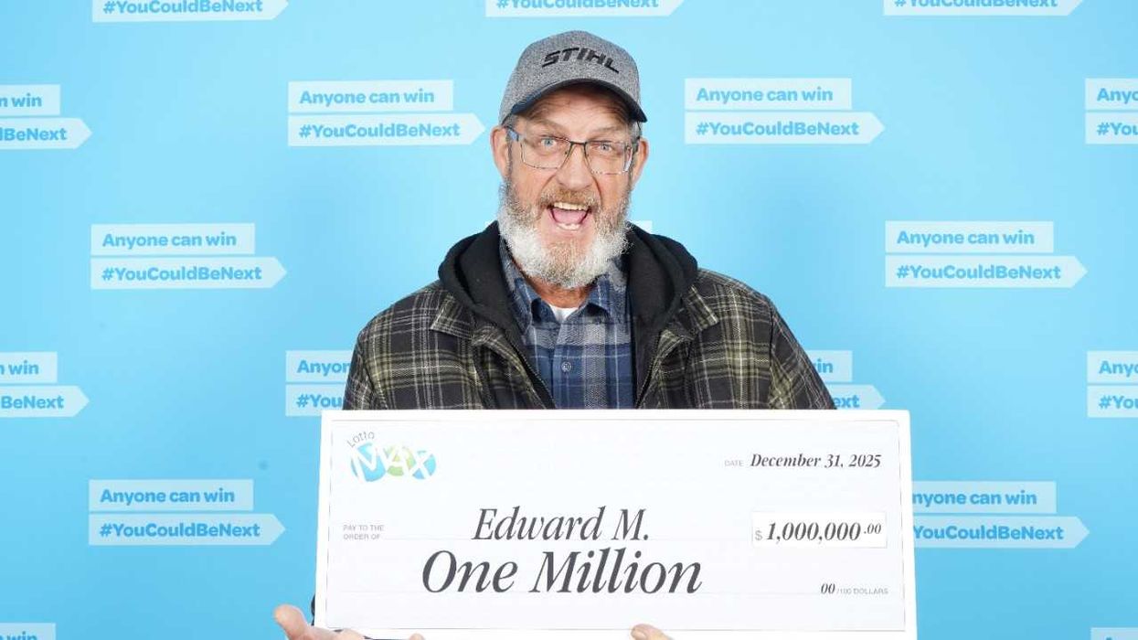 lotto max winner edward m holding a $1 million cheque