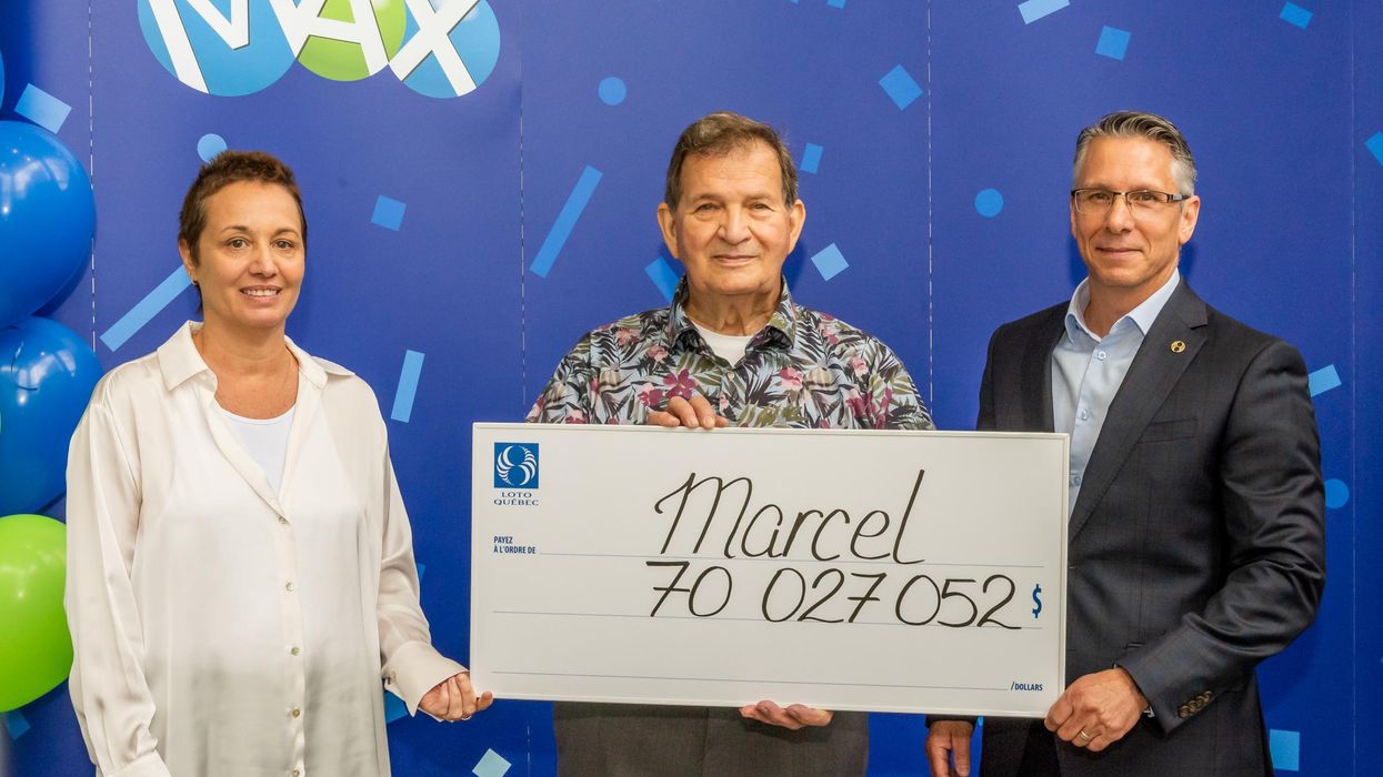 Lotto Max winner Marcel Lussier with his $70 million cheque.