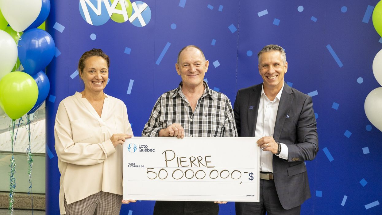 Lotto Max winner Pierre Richer with a $50 million cheque.