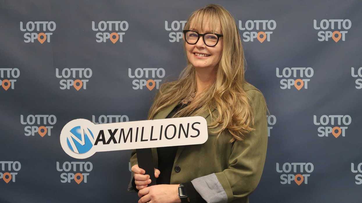 lotto max winner Sandra Mogdan holding maxmillions sign