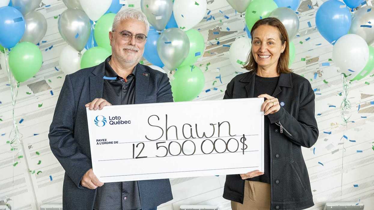 lotto max winner shawn batten holding a $12.5 million cheque